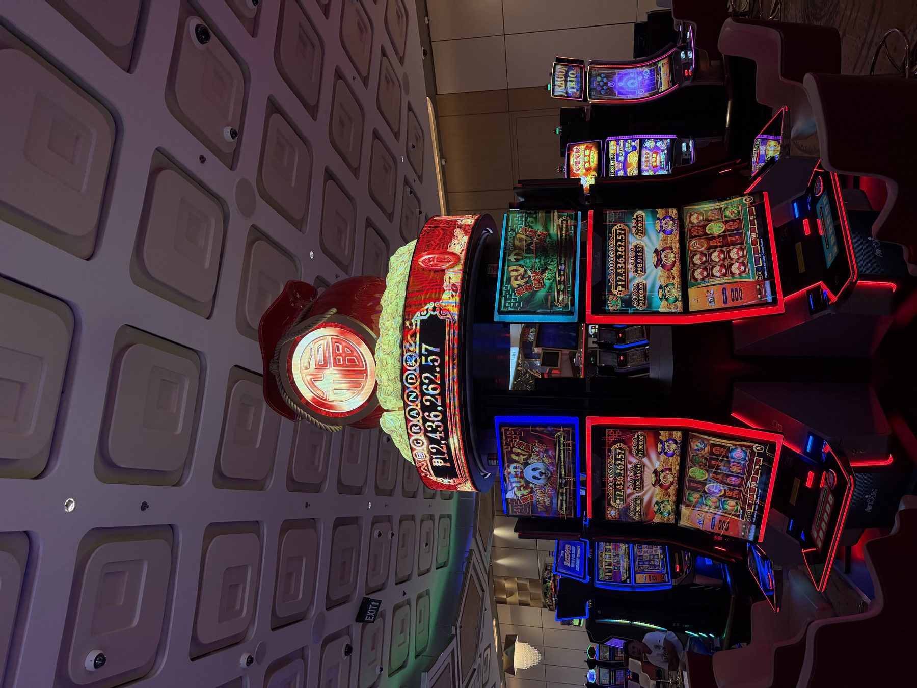A round LED topper with a red money bag above a circular bank of machines